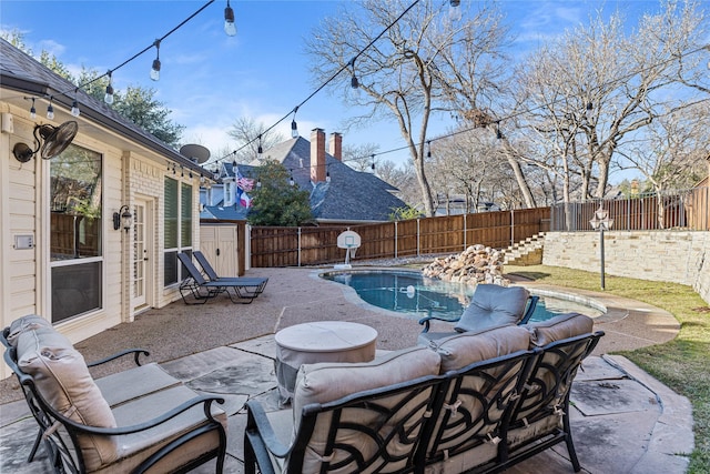 view of patio featuring a fenced in pool, an outdoor hangout area, and a storage unit