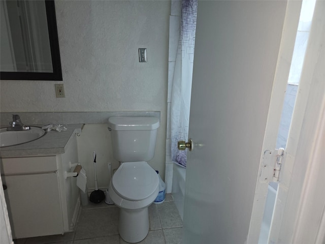 bathroom with tile patterned floors, vanity, and toilet