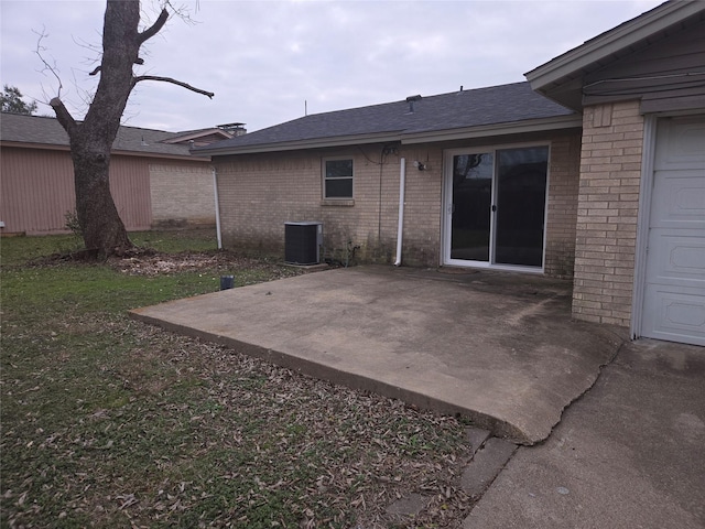 rear view of house with a patio area and central AC unit