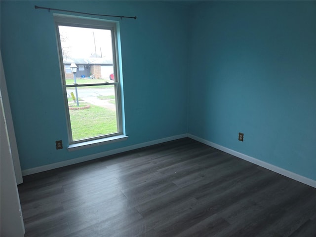 spare room featuring dark hardwood / wood-style flooring