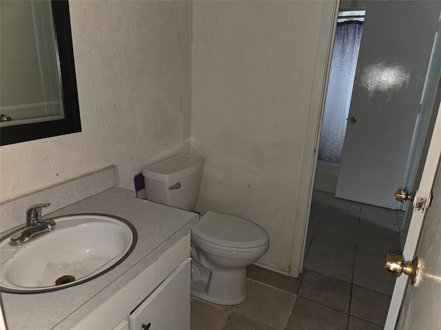 bathroom featuring tile patterned flooring, vanity, and toilet