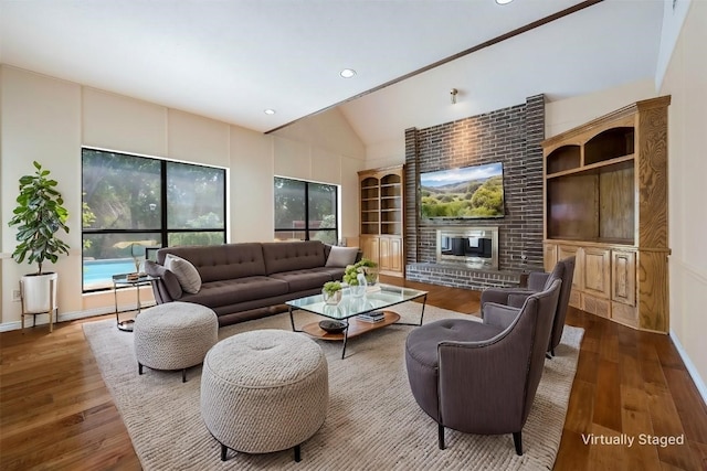 living room with hardwood / wood-style floors and lofted ceiling