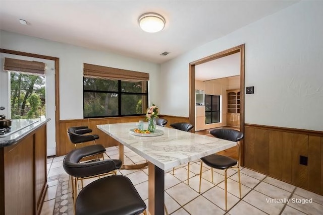 dining room with wood walls