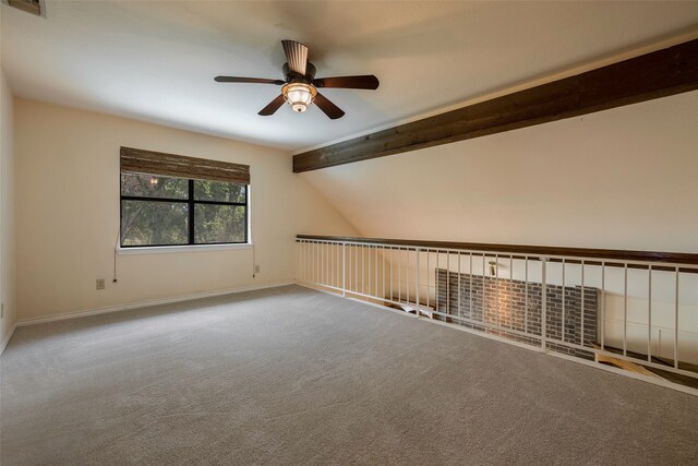 carpeted empty room with lofted ceiling with beams and ceiling fan