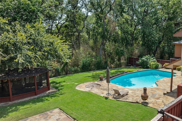 view of pool with a patio area and a lawn