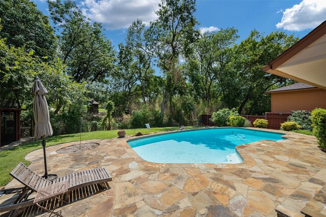 view of pool featuring a patio area and a yard