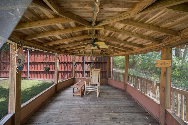 unfurnished sunroom featuring ceiling fan and lofted ceiling