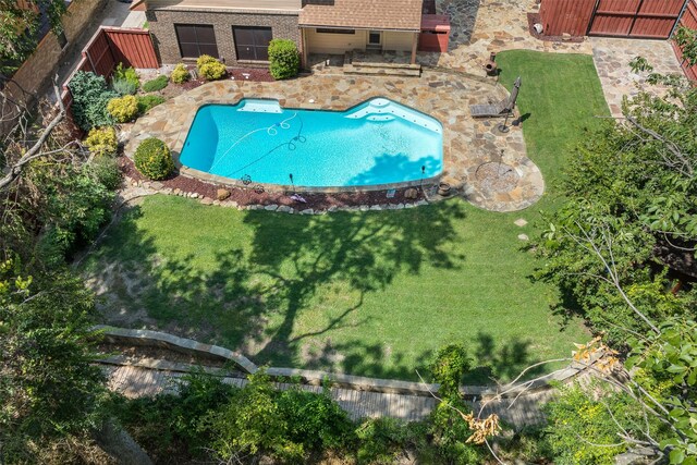 view of pool with a yard and a patio