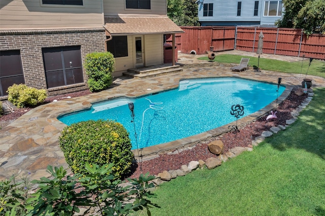 view of swimming pool featuring a patio and a lawn