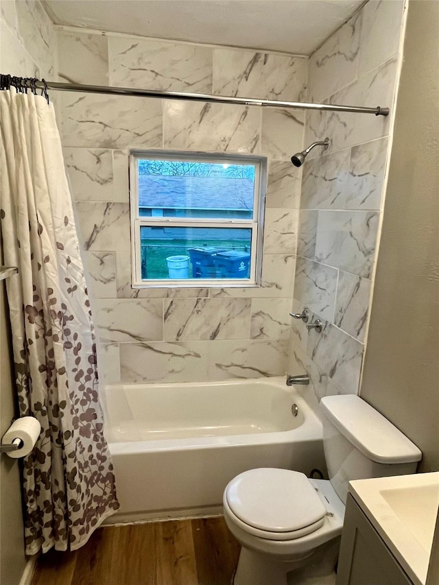 full bathroom featuring hardwood / wood-style flooring, vanity, toilet, and shower / bathtub combination with curtain