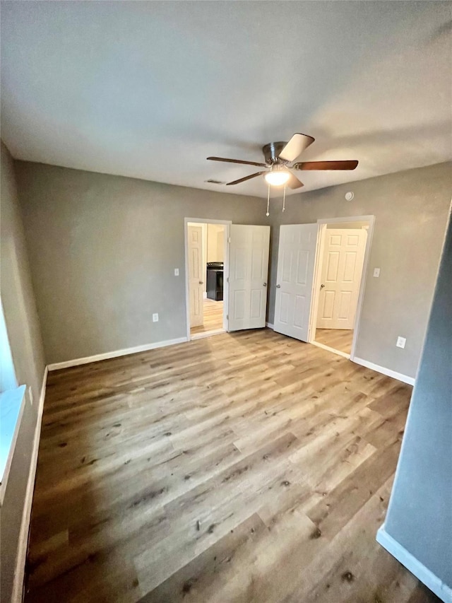 unfurnished bedroom with ceiling fan and light hardwood / wood-style flooring