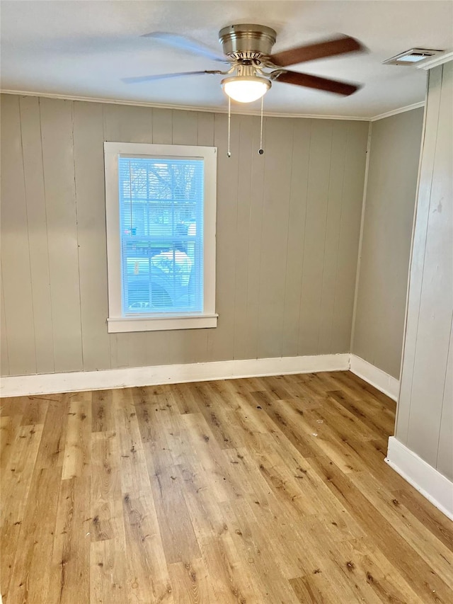 unfurnished room with crown molding, ceiling fan, and light hardwood / wood-style floors