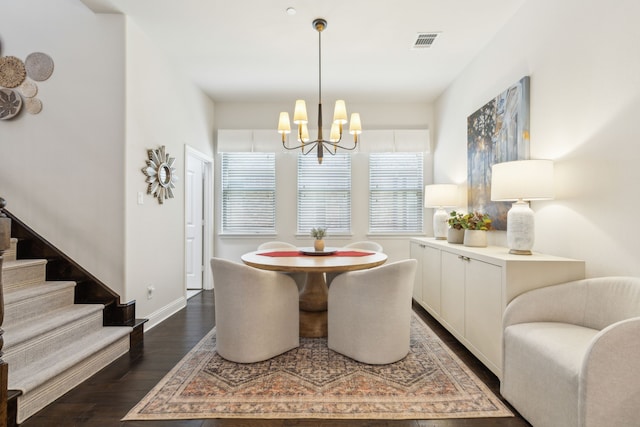 dining area with a chandelier and dark hardwood / wood-style flooring