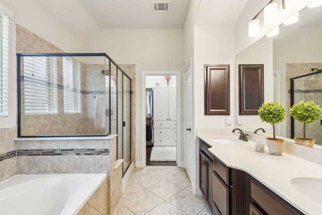 bathroom with tile patterned floors, vanity, and plus walk in shower