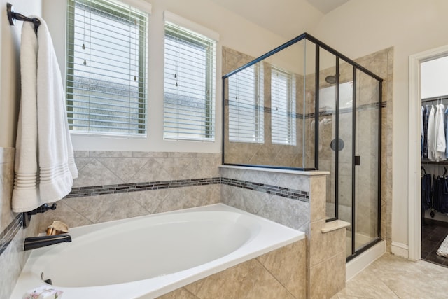 bathroom with tile patterned floors and plus walk in shower