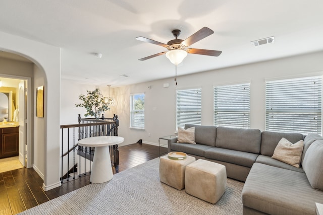 living room featuring dark hardwood / wood-style floors and ceiling fan