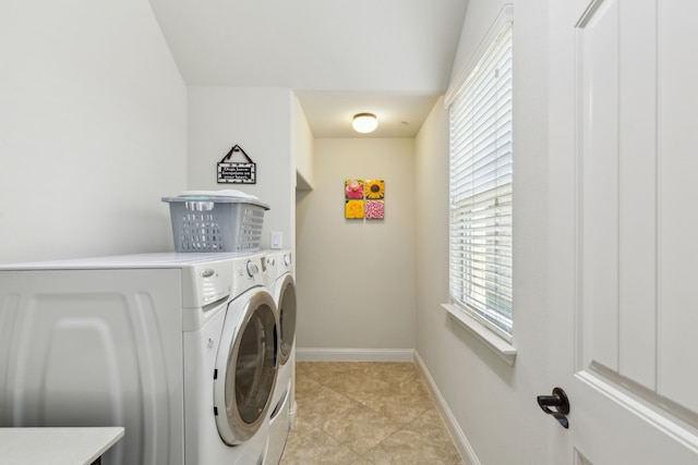 laundry area featuring washer and dryer and light tile patterned floors