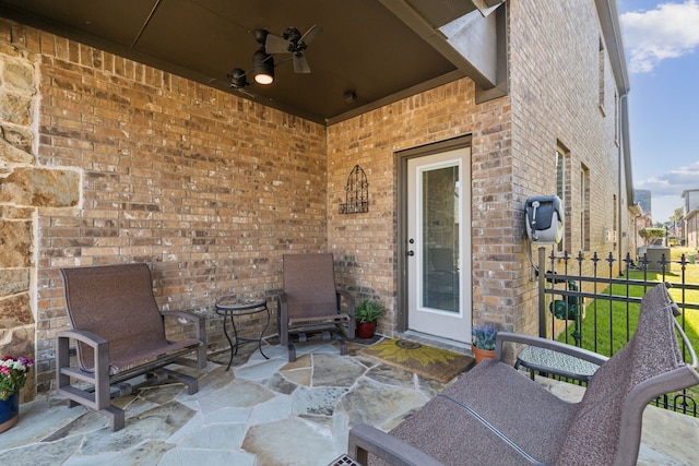 doorway to property featuring ceiling fan and a patio