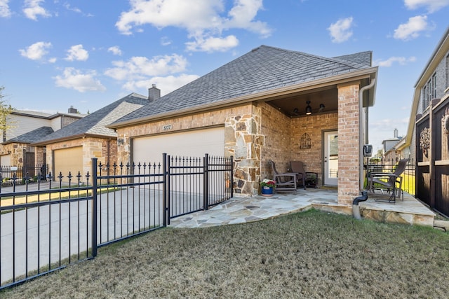 back of property with a yard and a garage