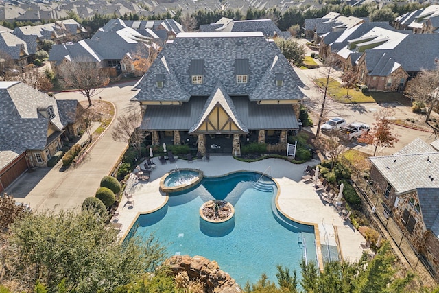 view of swimming pool featuring a patio area and an in ground hot tub