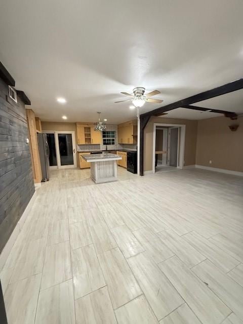 unfurnished living room with ceiling fan with notable chandelier