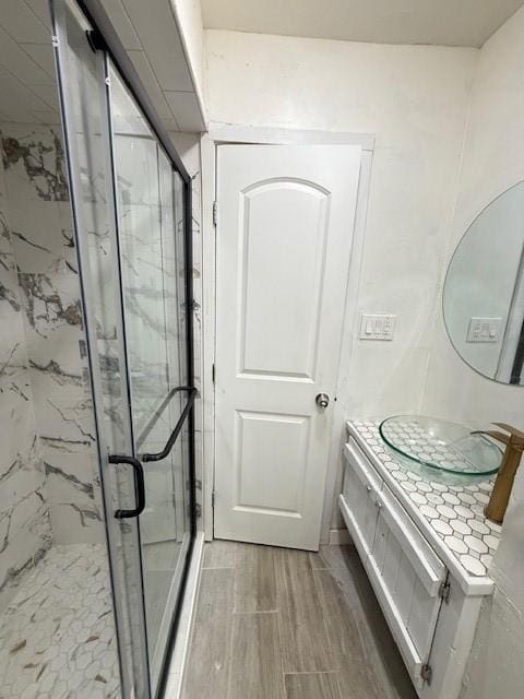 bathroom featuring vanity and a shower with shower door