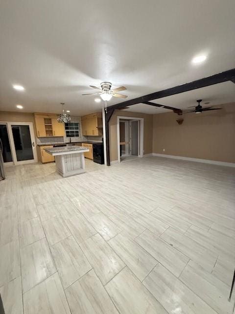 unfurnished living room with ceiling fan with notable chandelier and beam ceiling