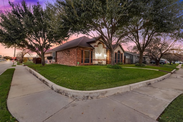 ranch-style home with a yard