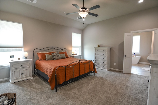 carpeted bedroom featuring lofted ceiling, multiple windows, and ceiling fan