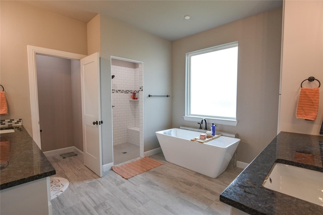 bathroom featuring vanity, hardwood / wood-style floors, and shower with separate bathtub