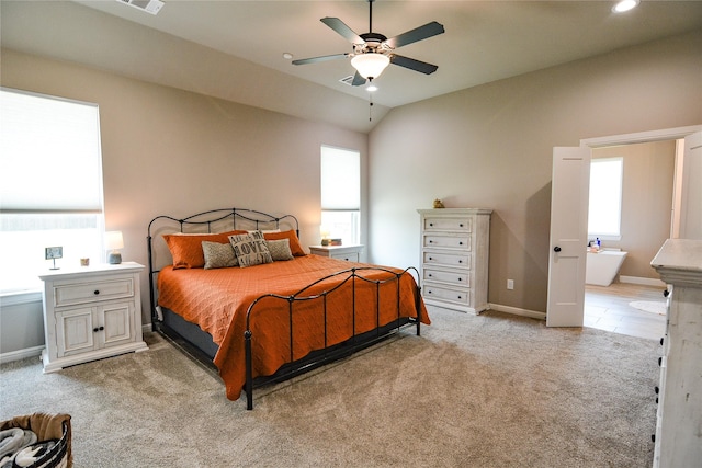 bedroom with visible vents, baseboards, vaulted ceiling, and light colored carpet