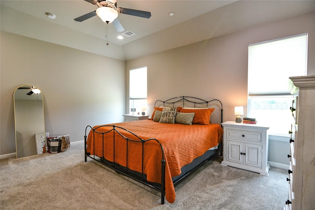 bedroom with light colored carpet, visible vents, and baseboards