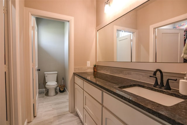 bathroom featuring vanity and toilet