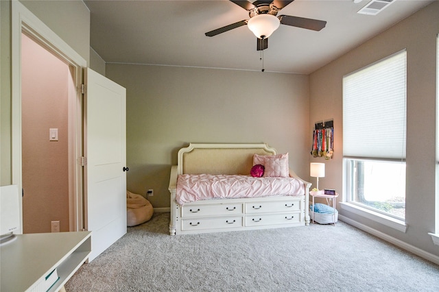 unfurnished bedroom with a ceiling fan, carpet, visible vents, and baseboards