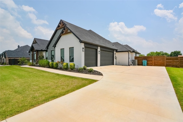 view of front of house with concrete driveway, an attached garage, fence, cooling unit, and a front lawn