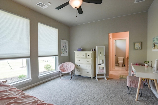 bedroom with light carpet, a ceiling fan, visible vents, and baseboards