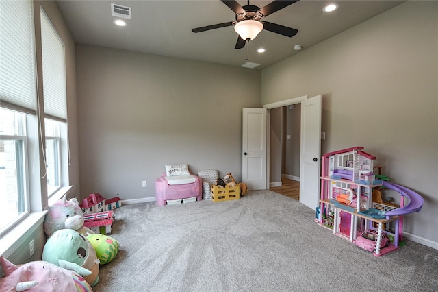 rec room with ceiling fan and carpet flooring