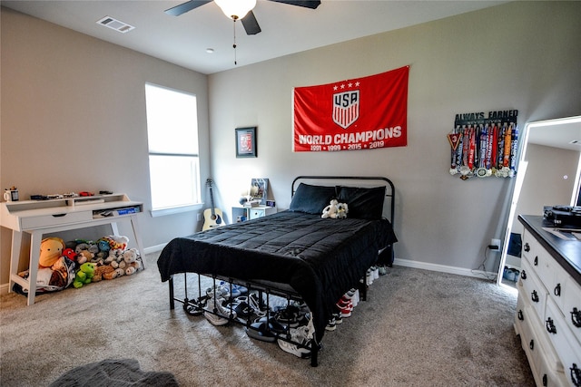 carpeted bedroom featuring ceiling fan, visible vents, and baseboards