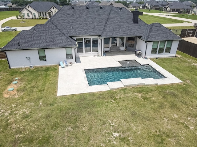 back of property featuring a patio and a lawn