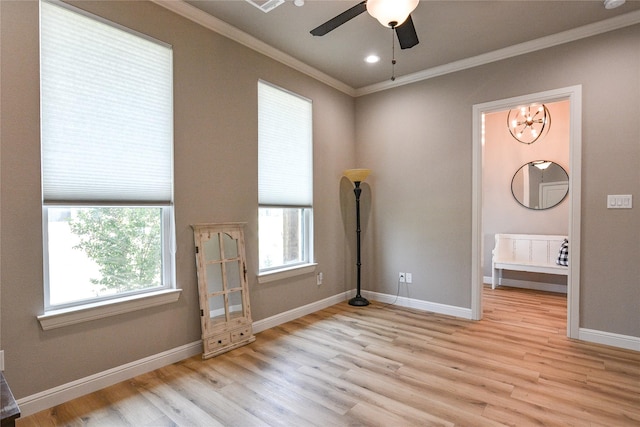 unfurnished bedroom with crown molding, light wood-style flooring, and baseboards