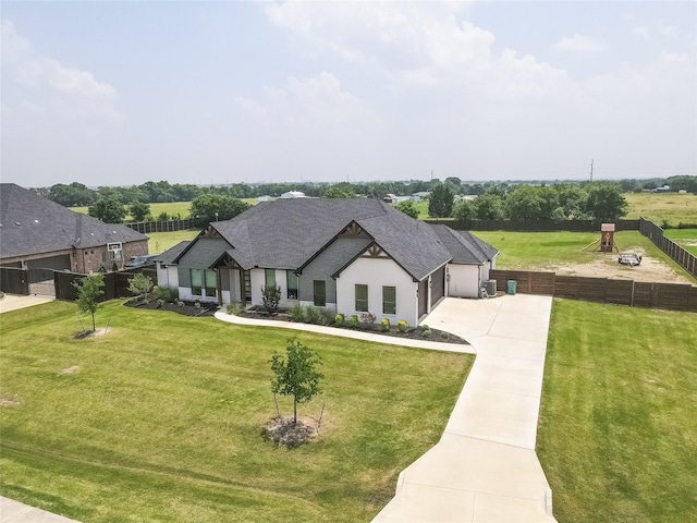 view of front of house with a garage and a front lawn