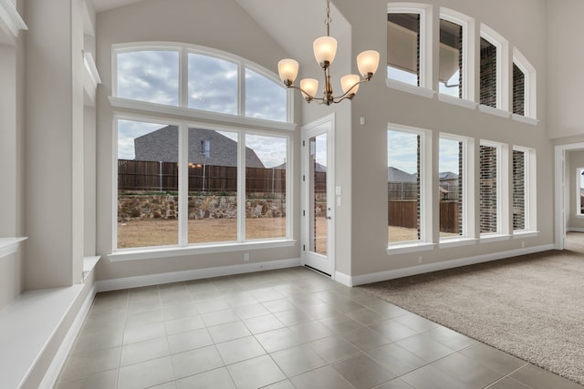 interior space featuring lofted ceiling and a chandelier