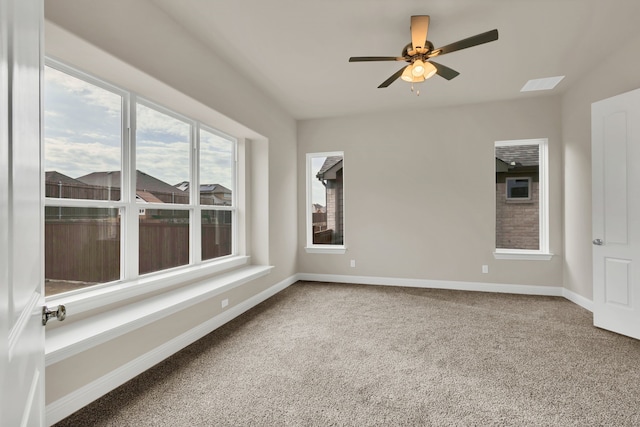 carpeted spare room featuring ceiling fan