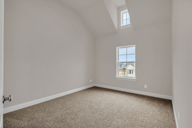 bonus room with carpet flooring and vaulted ceiling