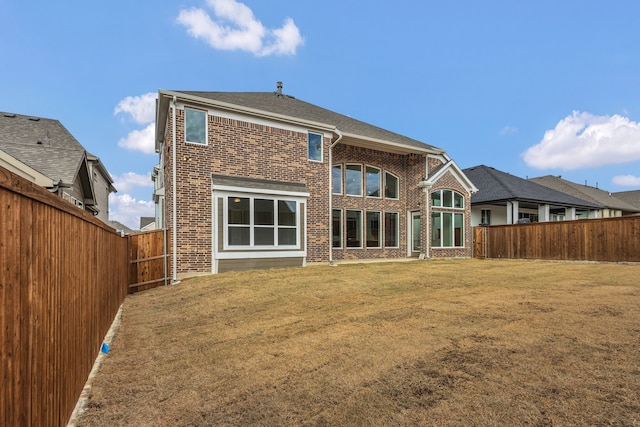 rear view of property featuring a yard