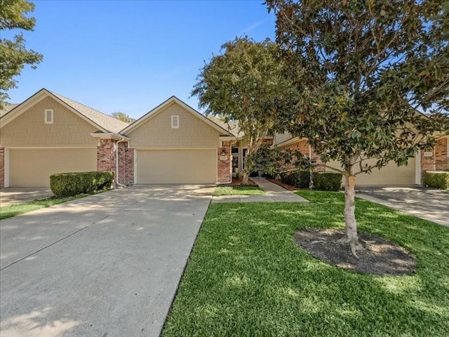 view of front of property with a front yard and a garage