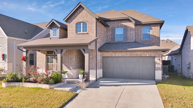 view of front of home with central AC unit, a garage, and a front yard