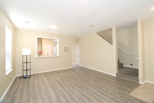 empty room featuring wood-type flooring and a wealth of natural light