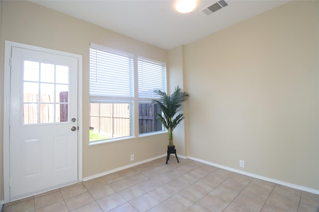 doorway featuring light tile patterned flooring