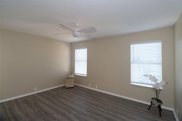 empty room featuring dark hardwood / wood-style flooring and ceiling fan